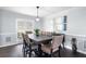 Stylish dining room with a large table, wainscoting, and modern decor at 3174 Country Club Nw Ct, Kennesaw, GA 30144