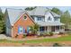 Charming two-story home with brick facade, blue shutters, inviting front porch, and well-manicured lawn at 3174 Country Club Nw Ct, Kennesaw, GA 30144