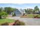 Charming home with a well-manicured lawn, mature landscaping, and a spacious driveway at 3174 Country Club Nw Ct, Kennesaw, GA 30144