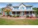 Charming home with a welcoming front porch, manicured lawn and blue shutters at 3174 Country Club Nw Ct, Kennesaw, GA 30144