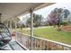 Charming front porch with a hanging chair and a view of the landscaped front yard at 3174 Country Club Nw Ct, Kennesaw, GA 30144