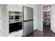 Kitchen featuring stainless steel appliances and convenient pantry access at 3174 Country Club Nw Ct, Kennesaw, GA 30144