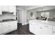 Open kitchen with white cabinets and countertops, stainless appliances, and dark hardwood floors at 3174 Country Club Nw Ct, Kennesaw, GA 30144