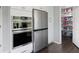 Kitchen with stainless steel refrigerator, double oven, custom white cabinets, and large pantry at 3174 Country Club Nw Ct, Kennesaw, GA 30144