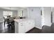 Kitchen island featuring white cabinets and marble countertop, adjacent to dining area at 3174 Country Club Nw Ct, Kennesaw, GA 30144