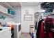 Functional laundry room with a washer, a dryer, storage shelves, and 'laundry' signage on the wall at 3174 Country Club Nw Ct, Kennesaw, GA 30144