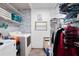 Well-lit laundry room with washer, dryer, folding shelves and storage, great for convenient home upkeep at 3174 Country Club Nw Ct, Kennesaw, GA 30144