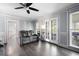 Elegant living room with hardwood floors, stylish gray walls, and French doors leading to a deck at 3174 Country Club Nw Ct, Kennesaw, GA 30144