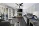 Comfortable living room with fireplace, ceiling fan, dark hardwood floors, and French doors at 3174 Country Club Nw Ct, Kennesaw, GA 30144