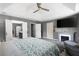 Spacious main bedroom with a tray ceiling, fireplace, and en suite bathroom at 3174 Country Club Nw Ct, Kennesaw, GA 30144