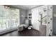 Cozy sitting room featuring a comfortable chair, ottoman, and natural light from the window at 3174 Country Club Nw Ct, Kennesaw, GA 30144