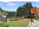 Landscaped backyard with a fenced garden area, storage shed, and wooden deck off the house at 3503 Dunbar Ln, Suwanee, GA 30024