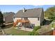 Exterior of home with a spacious backyard, deck, and lower level patio area at 3503 Dunbar Ln, Suwanee, GA 30024