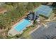 Aerial view of a sparkling pool, pool house, and ample parking in a well-maintained community at 3503 Dunbar Ln, Suwanee, GA 30024