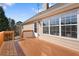 Wooden deck with railing, accessed from the home's exterior, with large windows bringing in light at 3503 Dunbar Ln, Suwanee, GA 30024