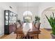 Dining room with hardwood floors, a decorative chandelier, large windows, and neutral wall color at 3503 Dunbar Ln, Suwanee, GA 30024