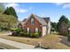 Charming red-brick home with manicured landscaping and lush green lawn at 3503 Dunbar Ln, Suwanee, GA 30024