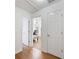 Hallway with hardwood flooring leading to a bedroom with a ceiling fan at 3503 Dunbar Ln, Suwanee, GA 30024