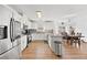 Bright kitchen with stainless steel appliances, white cabinetry, and wood flooring at 3503 Dunbar Ln, Suwanee, GA 30024