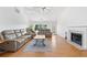 Comfortable living room with hardwood flooring, fireplace, and a view of the backyard at 3503 Dunbar Ln, Suwanee, GA 30024