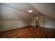 Bright attic space with hardwood flooring, neutral paint and door to access other rooms at 2048 Kelvin Dr, Lawrenceville, GA 30043