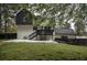 Spacious backyard features a dark wood deck, a concrete patio, and a grassy lawn area at 2048 Kelvin Dr, Lawrenceville, GA 30043