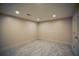 Bright basement area features tile flooring, recessed lighting and neutral paint at 2048 Kelvin Dr, Lawrenceville, GA 30043