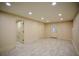 Finished basement with tile flooring, recessed lighting, and multiple doors at 2048 Kelvin Dr, Lawrenceville, GA 30043