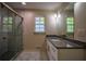 Bathroom featuring a walk-in shower with marble and glass door at 2048 Kelvin Dr, Lawrenceville, GA 30043