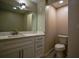 Bathroom with modern vanity, toilet, and a large mirror with vanity lighting at 2048 Kelvin Dr, Lawrenceville, GA 30043