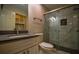 Well-lit bathroom features a glass enclosed shower with dark marble style accents and granite countertop sink at 2048 Kelvin Dr, Lawrenceville, GA 30043