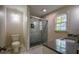 Updated bathroom featuring a glass-enclosed shower, tiled floors, and a granite vanity at 2048 Kelvin Dr, Lawrenceville, GA 30043