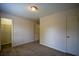 Bedroom with neutral walls and a window with a closet to the left at 2048 Kelvin Dr, Lawrenceville, GA 30043