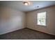Bedroom features neutral paint, carpeted floors, and a window providing natural light at 2048 Kelvin Dr, Lawrenceville, GA 30043