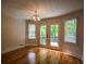 An open dining area featuring hardwood floors, natural light, and stylish lighting fixture at 2048 Kelvin Dr, Lawrenceville, GA 30043