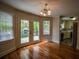 Bright dining area featuring hardwood floors and double doors leading to a deck at 2048 Kelvin Dr, Lawrenceville, GA 30043