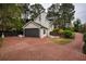 A long driveway made of brick leads to a detached garage at 2048 Kelvin Dr, Lawrenceville, GA 30043