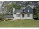 Charming home featuring white painted brick, dark trim, and a brick walkway leading to the front door at 2048 Kelvin Dr, Lawrenceville, GA 30043