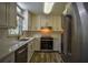 Modern kitchen with white cabinets, stainless steel appliances, quartz countertops, and wood floors at 2048 Kelvin Dr, Lawrenceville, GA 30043