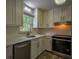 Well-lit kitchen features white cabinets, stainless steel appliances, and modern finishes at 2048 Kelvin Dr, Lawrenceville, GA 30043