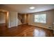 Bright living room with hardwood floors, a window, and staircase access at 2048 Kelvin Dr, Lawrenceville, GA 30043
