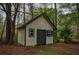 Exterior view of the outbuilding, situated amongst the trees, with access via double doors at 2048 Kelvin Dr, Lawrenceville, GA 30043