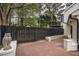 Charming brick patio features a dark wood privacy fence and a decorative owl statue at 2048 Kelvin Dr, Lawrenceville, GA 30043