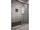 Shower stall with dark and white marble wall and floor tiles with black accent tiles and window at 2048 Kelvin Dr, Lawrenceville, GA 30043