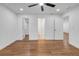 Bedroom showcases hardwood floors, white walls, recessed lights, and doorways to closets at 2095 Highway 20 Ne, Conyers, GA 30012