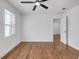 Bedroom featuring hardwood floors, a ceiling fan, and natural light at 2095 Highway 20 Ne, Conyers, GA 30012