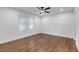 Bedroom with hardwood flooring, ceiling fan, and two windows offering natural light at 2095 Highway 20 Ne, Conyers, GA 30012