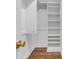 Walk-in closet with built-in shelving and hardwood floors offers ample storage space at 2095 Highway 20 Ne, Conyers, GA 30012