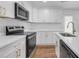 Sleek kitchen featuring quartz countertops, white cabinetry, and stainless steel appliances at 2095 Highway 20 Ne, Conyers, GA 30012