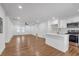 Open-concept living and kitchen area featuring stainless appliances, white cabinets, and hardwood floors at 2095 Highway 20 Ne, Conyers, GA 30012